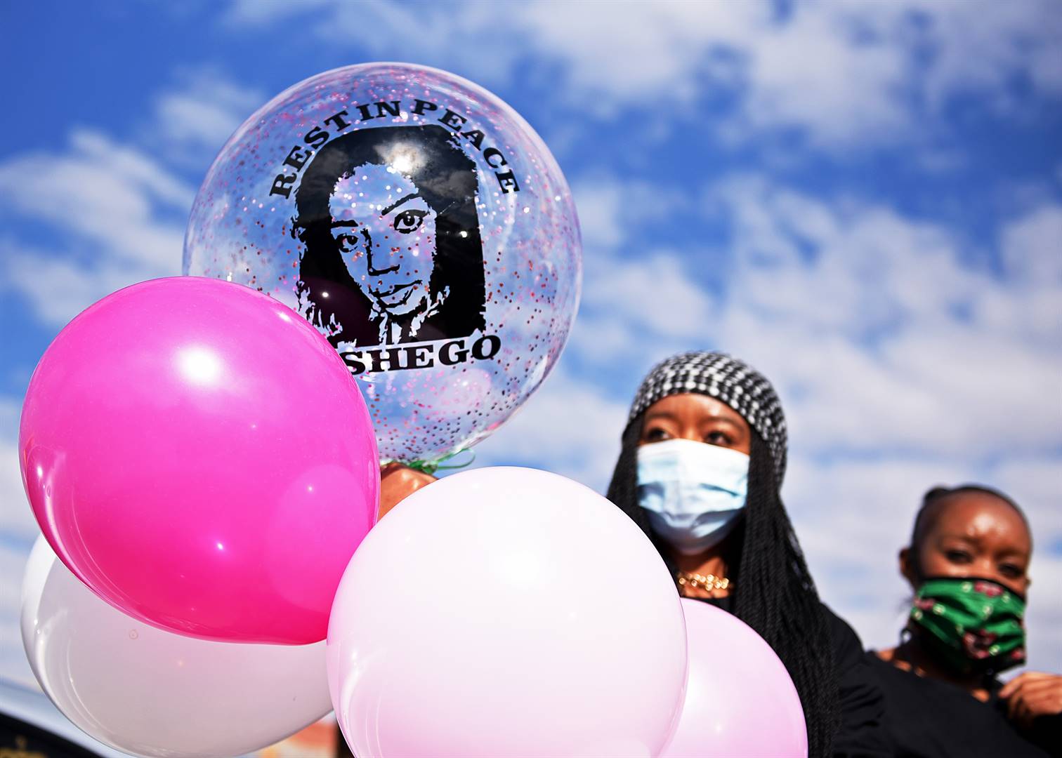 Friends and relatives of the slain 28-year-old Tshegofatso Pule holding balloons with one bearing her face with a message "Rest in Peace Tshego" in Meadowlands at her funeral on June 11 2020. Photo:Tebogo Letsie/City Press