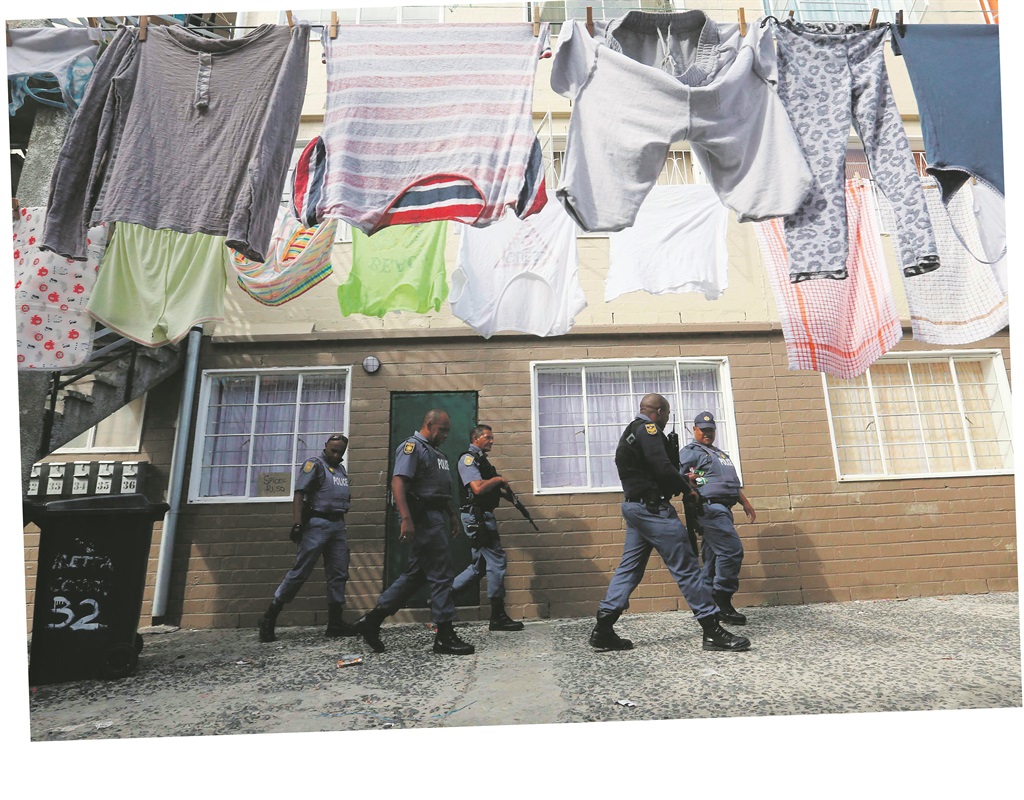 ON GUARD Policemen patrol the streets of the violence-stricken Manenberg community in Cape Town. This predominantly coloured neighbourhood is plagued by gang-related activities, and it recorded the third-highest drug-crime figures of all the country’s police precincts last year.  Picture: Esa Alexander 