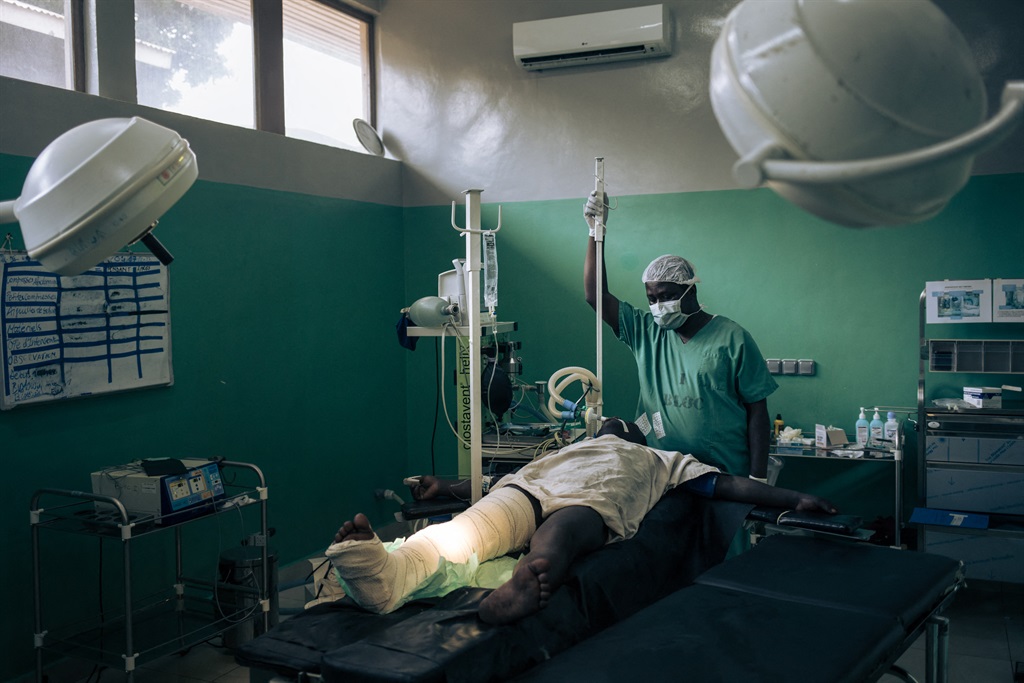 An anaesthesiologist waits for a patient with a gunshot wound in the leg to wake up after being re-dressed, at Rutshuru Hospital in the eastern province of North Kivu, Democratic Republic of Congo, on July 16, 2022.