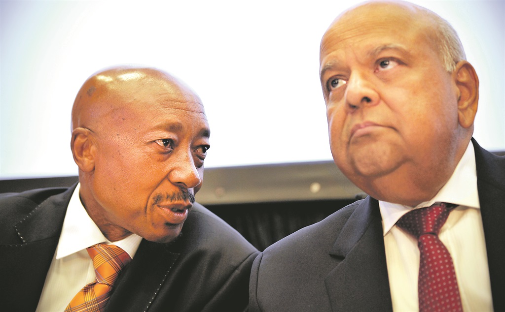 FACING FRONT Sars commissioner Tom Moyane shares a note with Finance Minister Pravin Gordhan during the announcement of the preliminary outcomes of the taxman’s revenue collection results for the fiscal year in Pretoria on Friday. Picture: Elizabeth Sejake 