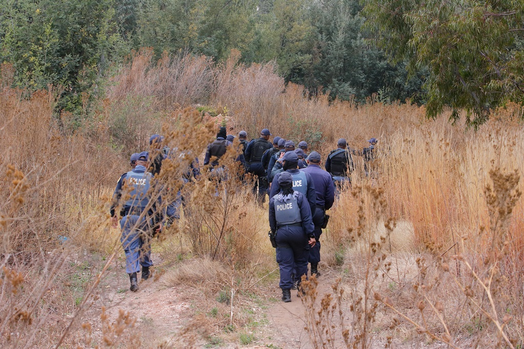 Authorities conduct a raid on illegal miners in Krugersdorp after eight women were raped in the area. 