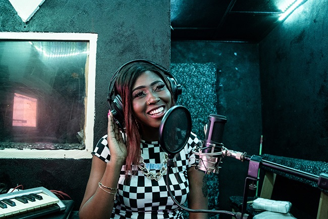 Princia Flora Plisson, also known as Cool Fawa, a rap artist and the most popular Central African woman on Instagram, trains her voice in a studio in Bangui.