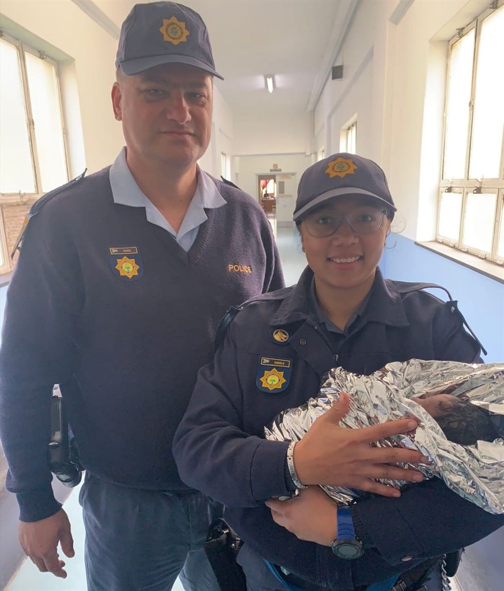 Warrant Officer Werner Maree and Constable Shaneez Daniels with the baby they rescued.