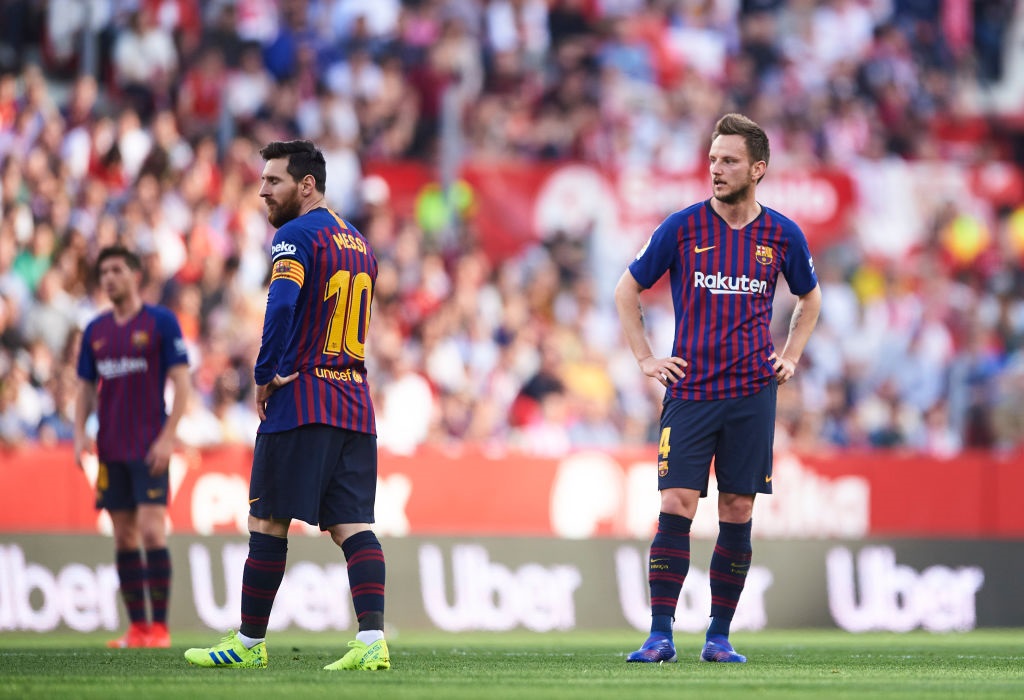 SEVILLE, SPAIN - FEBRUARY 23: Lionel Messi and Ivan Rakitic of FC Barcelona reacts during the La Liga match between Sevilla FC and FC Barcelona at Estadio Ramon Sanchez Pizjuan on February 23, 2019 in Seville, Spain. (Photo by Aitor Alcalde/Getty Images)