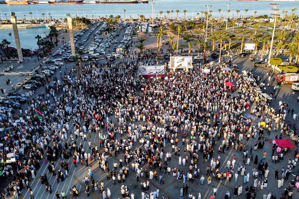 This aerial view shows demonstrators gathering for a rally in solidarity with the Palestinian people at the Martyrs' Square in Tripoli on 13 October 2023.