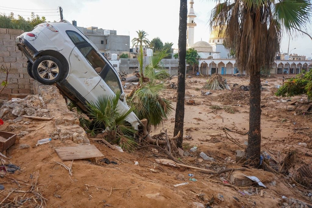 Vehicles are buried in mud and rubble in the aftermath of a devastating flood in eastern Libya's city of Derna, on 16 September 2023.