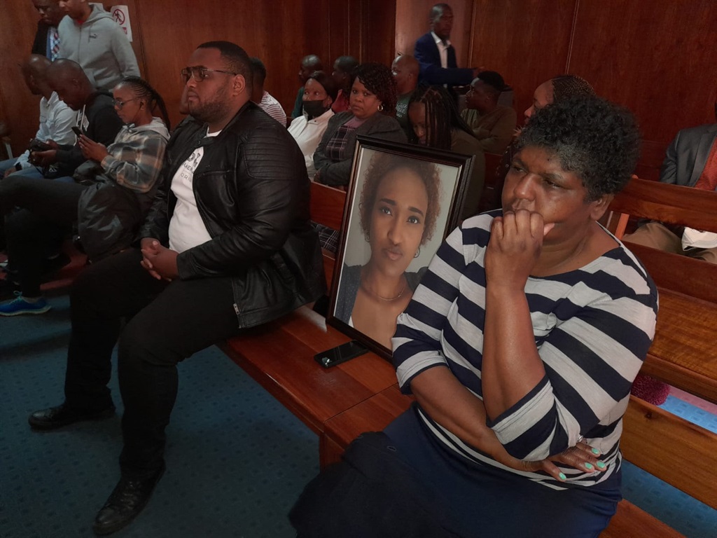 Relatives of the slain Hillary Gardee seated next to her picture in court. 