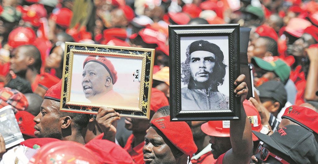 go to the people An Economic Freedom Fighters supporter holds up a picture of leader Julius Malema alongside a picture of Che Guevara during the party’s march to Constitution Hill in Johannesburg in February PHOTO: Michel Bega 