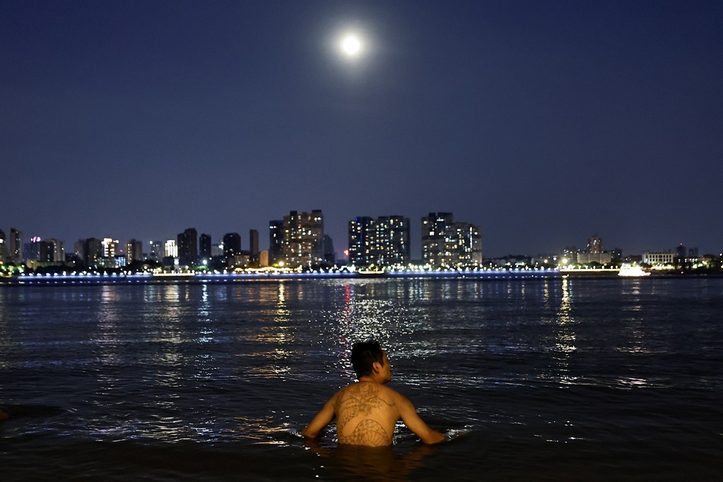 WUHAN, CHINA - AUGUST 10: (CHINA OUT) A man swims under the moonlight in the Yangtze River during a heat wave on August 10, 2022 in Wuhan, Hubei Province, China. (Photo by Getty Images)