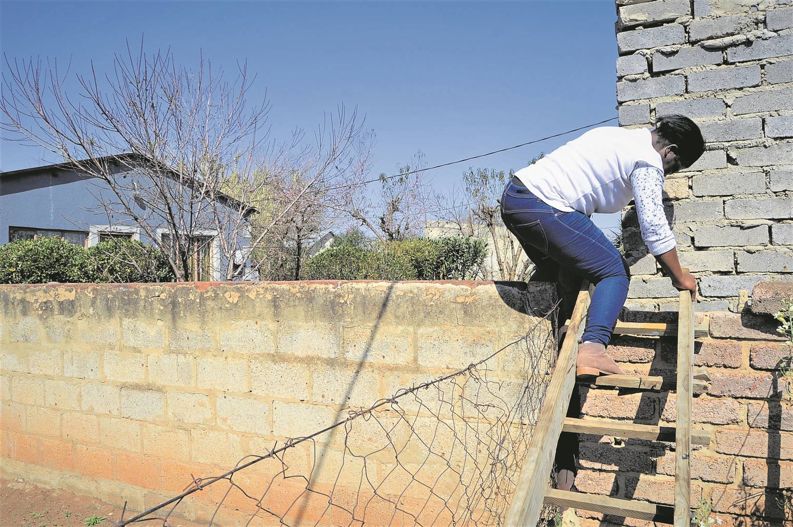 This ladder is the only way Sesi Makhaya can get in and out of home. Photo by Tumelo Mofokeng