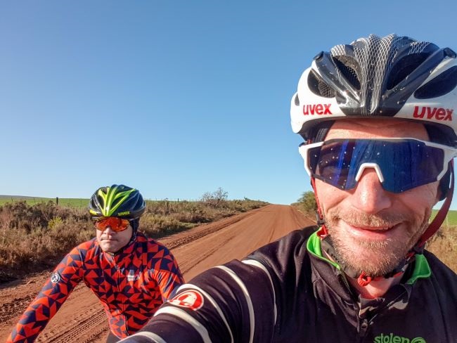 It is all fun and games, rolling along on a level dirt road. But the real Cape Epic test, is when it gets steep – either climbing or descending. (Photo: Ashley Oldfield)