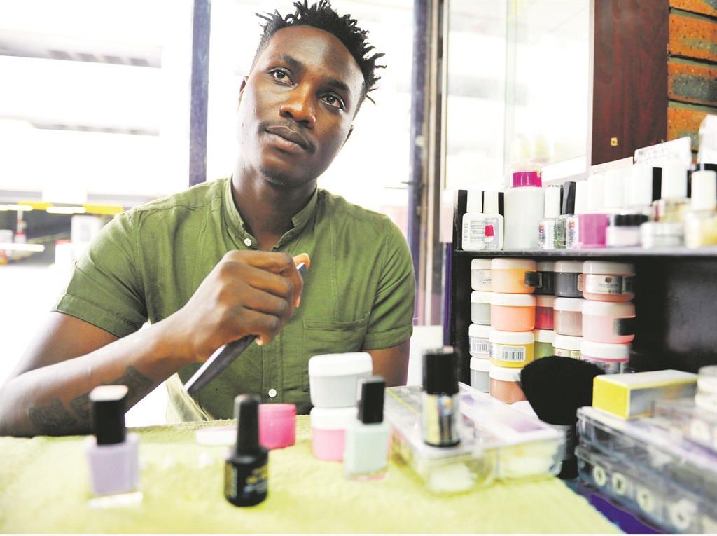 hitting the nail on the head Olaoluwa Olathunji at his nail parlour in Juta Street in Braamfontein, Johannesburg. He was inspired to start his own business at Chama Salon as a manicurist PHOTO: Lucky Nxumalo 