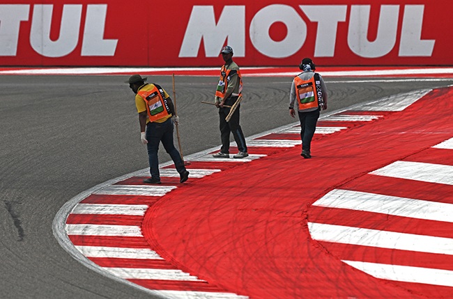 Track marshals inspect the track.