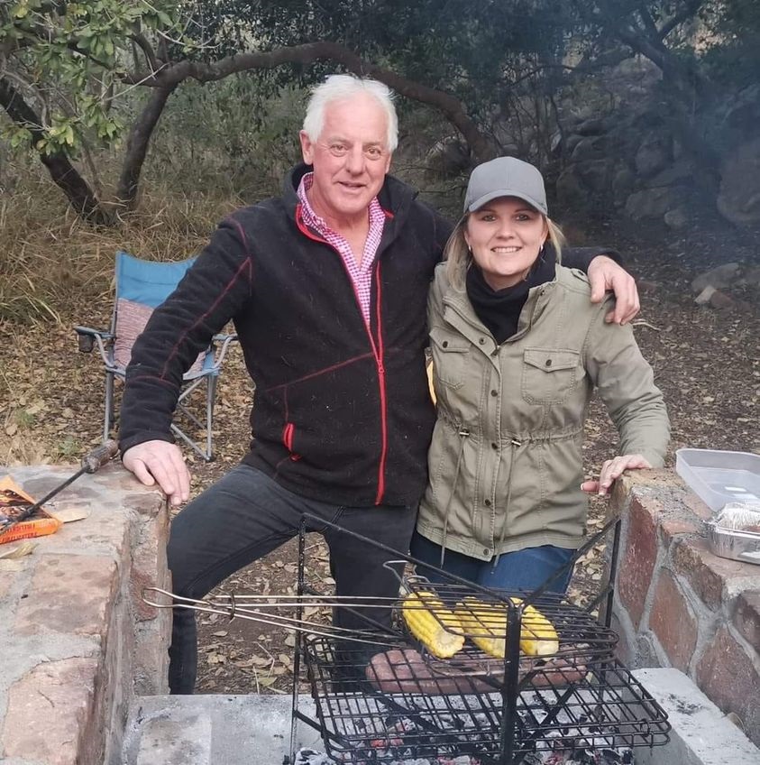 Frans Venter poses with woman in front of braai