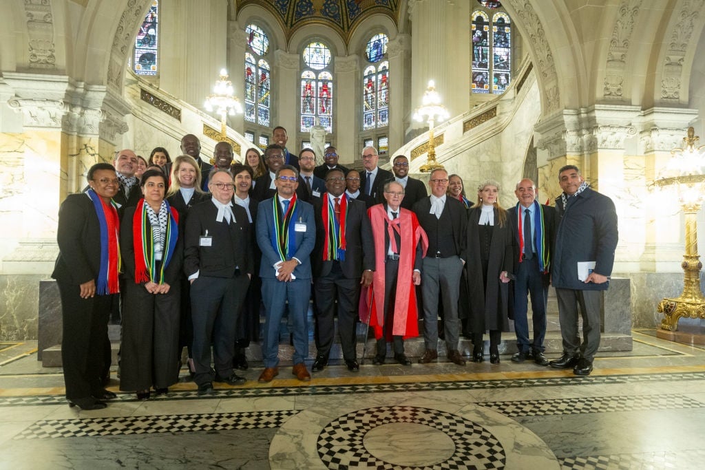 The South African delegation poses for a photo after arguing its case before the International Court of Justice.