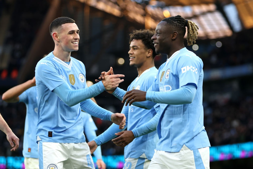 MANCHESTER, ENGLAND - JANUARY 07: Jeremy Doku of Manchester City celebrates scoring his teams fifth goal with teammate Phil Foden during the Emirates FA Cup Third Round match between Manchester City and Huddersfield Town at Etihad Stadium on January 07, 2024 in Manchester, England. (Photo by Clive Brunskill/Getty Images)
