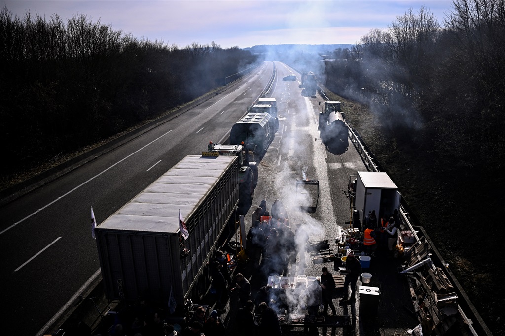 Protesting farmers gather with tractors to blockade the A16 highway, near Beauvais, some hundred kilometres north of Paris, on 28 January 2024, part of a nationwide campaign of protests called by several farmers unions on pay, tax and regulations. 