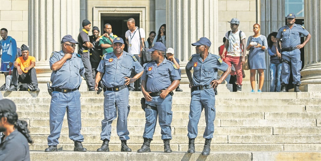 Policemen patrol the Wits University campus in Johannesburg during a protest in April against academic exclusion  PHOTO: moeletsi mabe / gallo ­images 