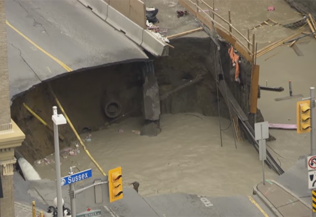 <B>SINKHOLE COMING TO TOWN:</B> This sinkhole almost swallowed the entire road and left bystanders and service providers all scrambling to find a solution. <I>Image: YouTube</I>