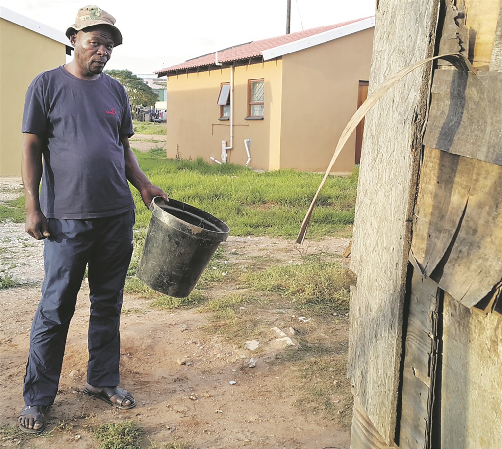 Mpumelelo Gantsho stands behind his house with his bucket toilet in Missionvale in Port Elizabeth this week Photo: Lubabalo Ngcukana 