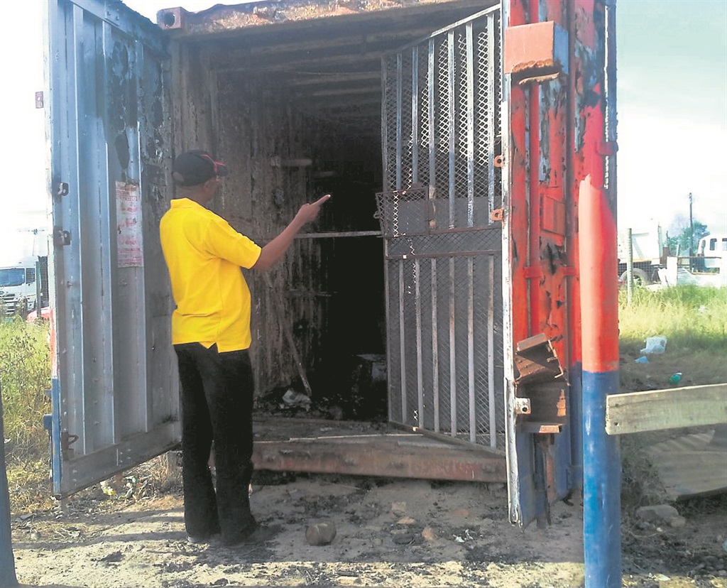 Mordekay Tadese outside his burnt container shop.                  Photo by Unathi Mshumpela 