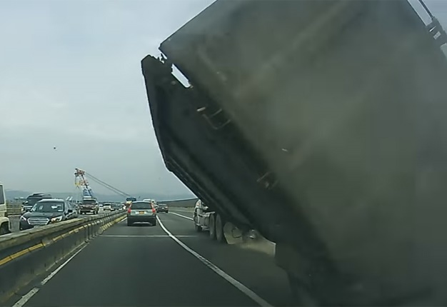 <B>BIG CRASH:</B> This truck overturned in the middle of traffic and left behind a trail of destruction. <I>Image: YouTube</I>
