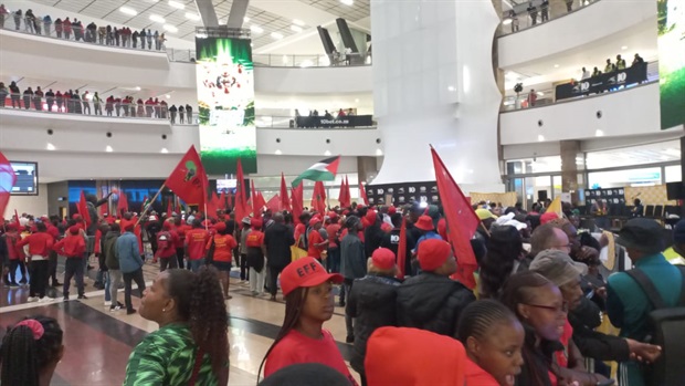 The sea of red remains in force here at OR Tambo International Airport as Bafana's arrival is eagerly awaited.
