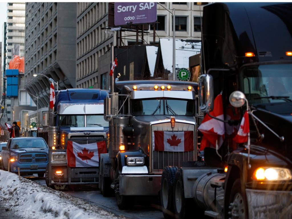 Trucks line Bloor near Yorkville in Toronto, Canad