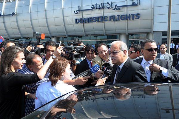 Egyptian Prime Minister Sherif Ismail talks to reporters at Cairo International Airport. (AP)