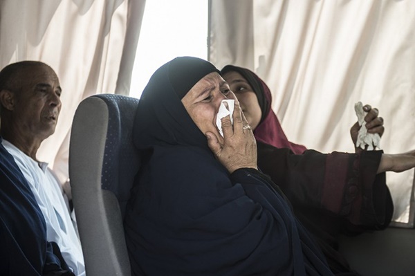 A relative of a passenger who was flying aboard an EgyptAir plane that vanished cries as family members are transported by bus to a gathering point at Cairo airport. (AFP)