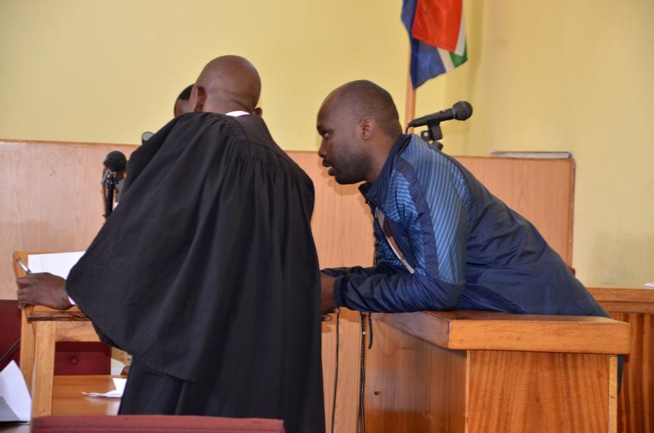 Cop Lolo Mabunda consulting with his lawyer, during his appearance in court on Friday. Photo by Tlangelani Khosa  
Source DailySun