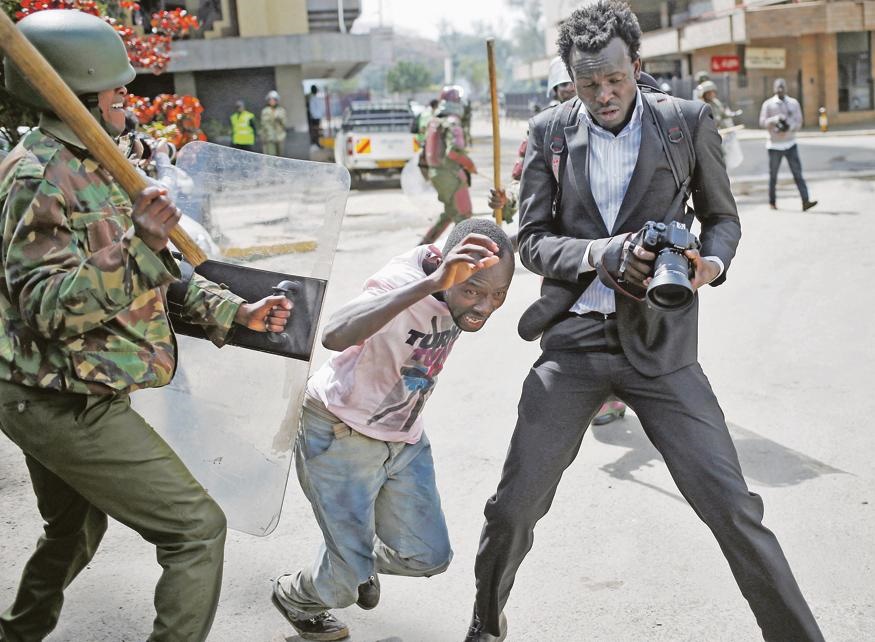A Kenyan policeman beats a protester during clashes in Nairobi, Kenya, on Monday. The violent assault was caught on camera and subsequently went viral. Inset: President Uhuru Kenyatta. Picture: Reuters