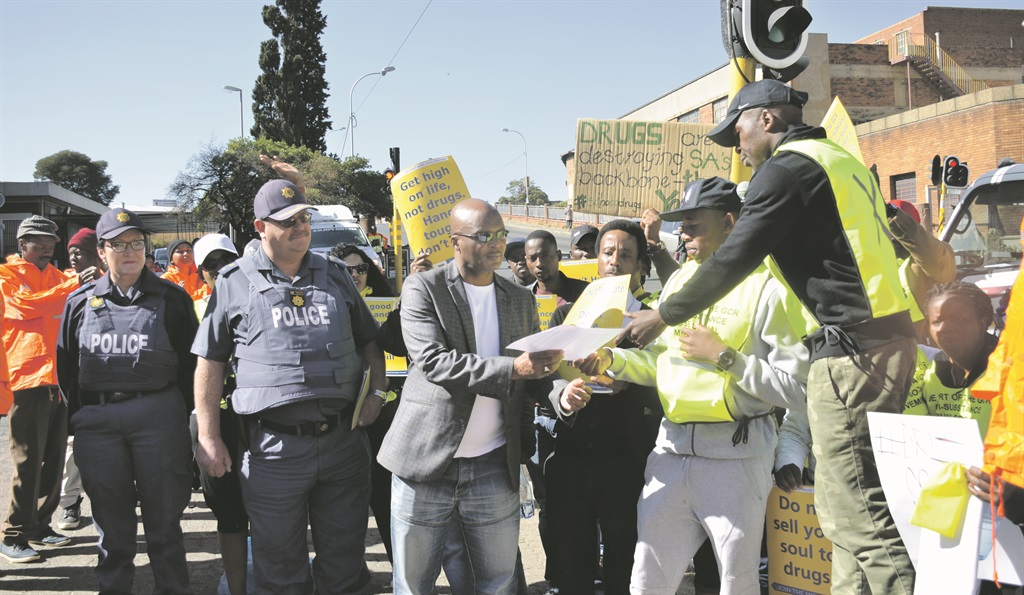 During an anti-drugs march in Joburg, kwaito musician Kabelo Mabalane (right) hands over a memorandum to Colonel Franse Matlabo.   Photo by Christopher Moagi 