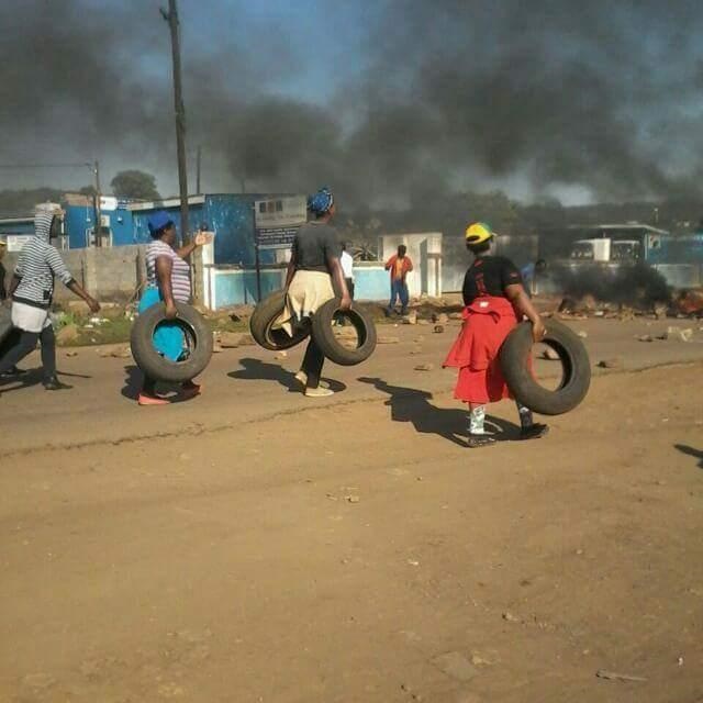 Residents of Jozini carry tyres that were later used to block roads into and out of the kasi as protesters demanded that the mayor step down for failing to solve the area’s water crisis. Photo supplied
