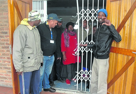 Members of the Tshangana Clinic committee inspect the damage after the attempted break-in.                 Photo by Chris Qwazi