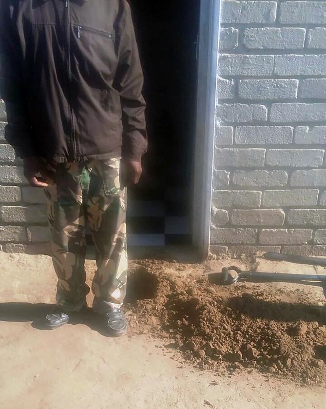 HORROR HOLE: The Clocolan muthi man stands next to the hole at his front door where a buried human head was found. 
