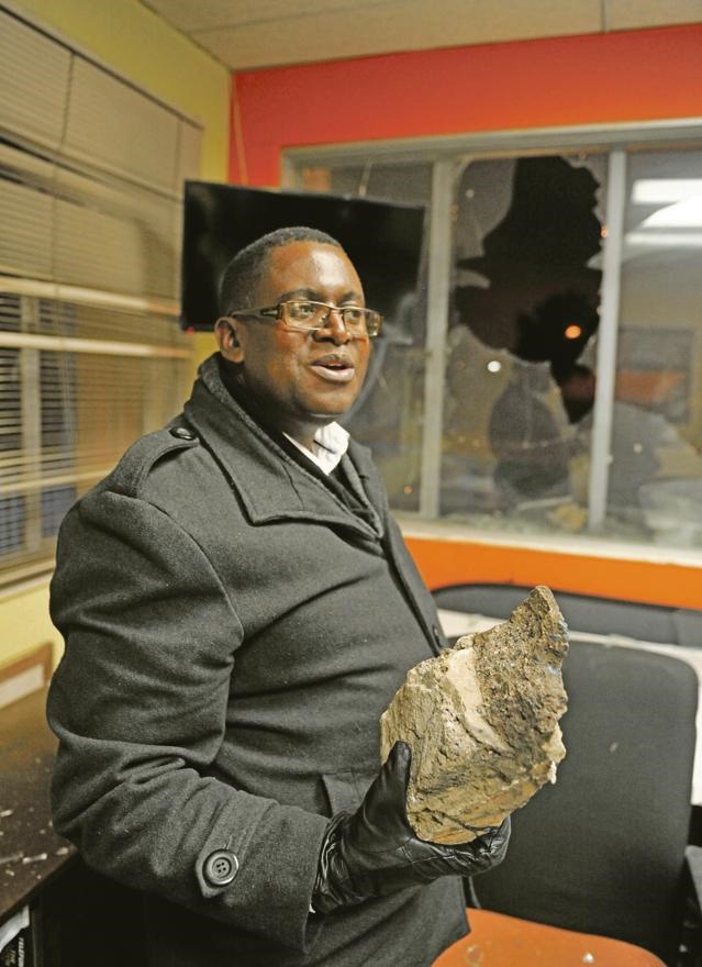 SHATTERED Mpho Mhlongo, CEO of Jozi FM, holds one of the rocks that was hurled through the studio windows. Picture: Lucky Nxumalo 