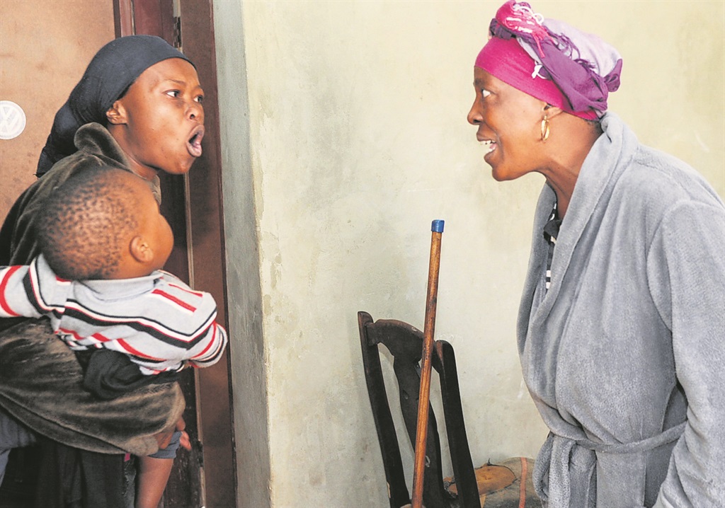 Bongi Thabethe (left) and Esther Tsaidume hurl insults at each other in Snake Park, Soweto.                                    Photo by Jabu Kumalo 