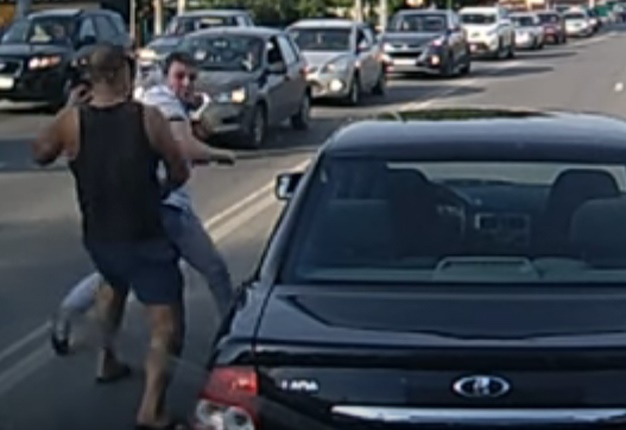 <B>SANITY LEFT THE BUILDING:</B> Road safety and common sense takes a backseat in this road-rage brawl. <I>Image: YouTube</I>