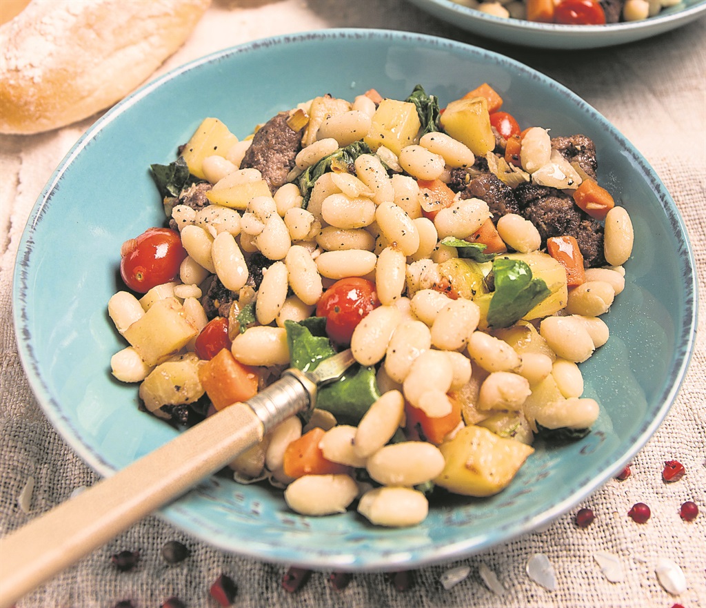 Small white beans with sausage and spinach Photo by   