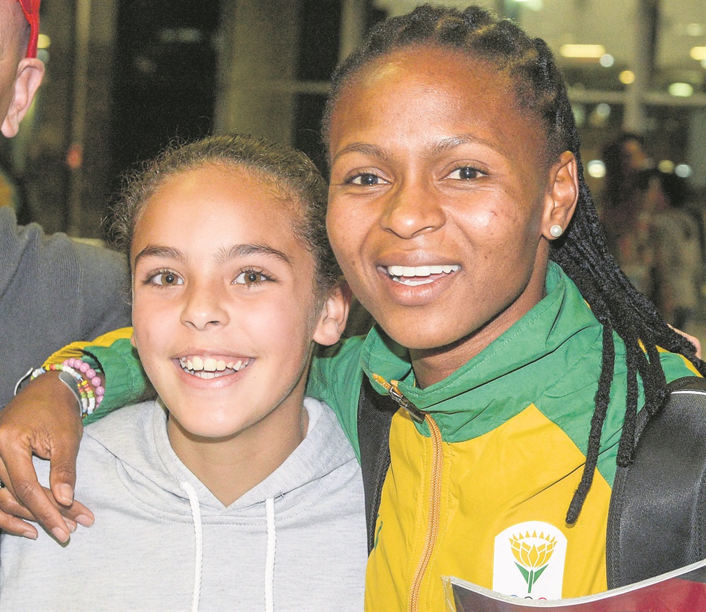 Banyana’s Amanda Dlamini (right) poses with a fan before the team’s departure to Rio. Photo by Gallo Images 