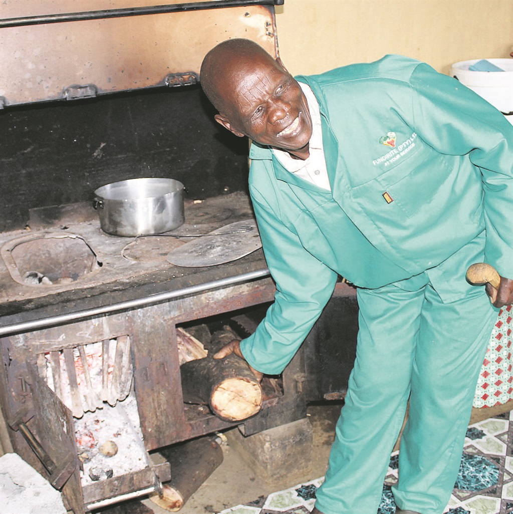 Stanford Mbuzwa shows off the stove he made. The retired welder works with metal when he isn’t farming  
