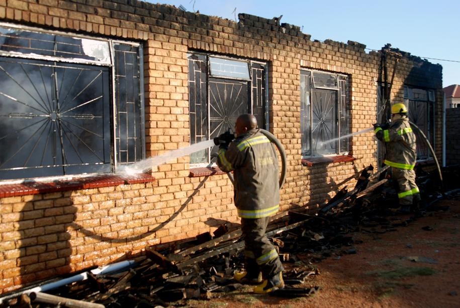  Firefighters bring the fire under control, but not before it had destroyed almost everything. 
Photos by Samson Ratswana
