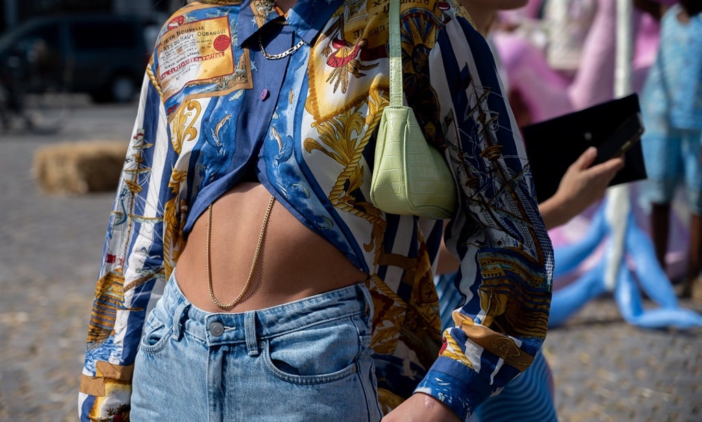 Andrea Steen outside Helmstedt wearing blue jeans, blue and yellow shirt and yellow hat  during Copenhagen fashion week SS21 on August 12, 2020 in Copenhagen, Denmark. Photo by Raimonda Kulikauskiene/ Getty Images
