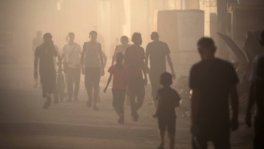 Palestinians find their way amid the dust and smok