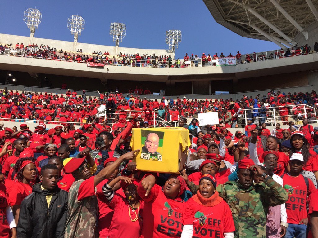 EFF supporters carry a coffin replica with an ANC t-shirt wrapped around it. Picture: Felix Dlangamandla