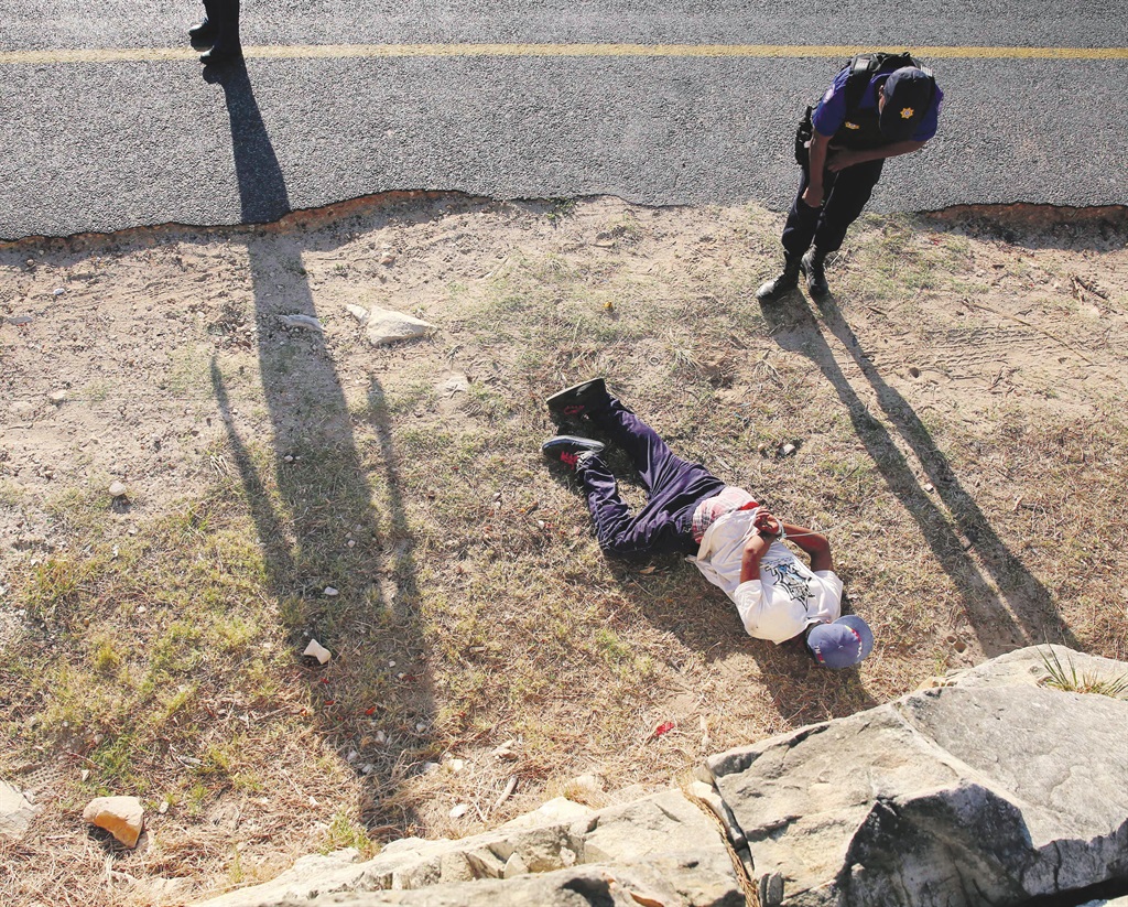 A man is laying on the floor, cuffed during the City of Cape Town’s Stabilisation Unit recent arrest operation on March 05, 2016 in Cape Town, South Africa. The unit conducted the operation in the wake of drugs, illegal firearms and gangsterism in the area. Eight suspects were arrested. Picture: Gallo Images / Esa Alexander
