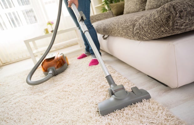 vacuuming a rug