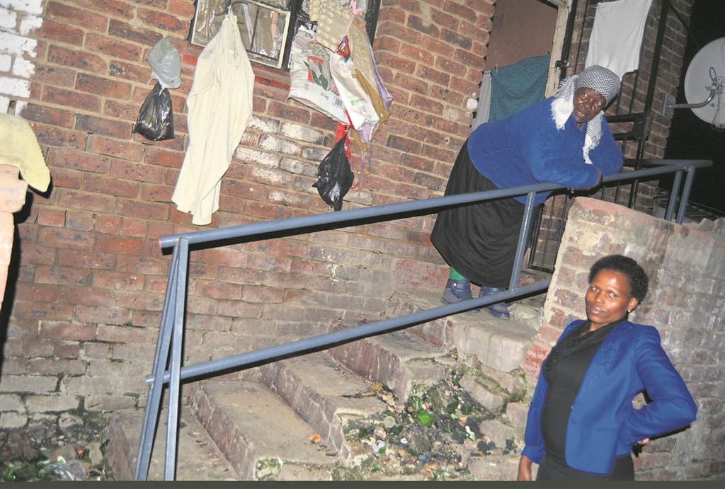 Nelly Maseko stands over neighbour, Nonky Maloma, who says she has pleaded with the gogo to stop hanging her panties from the burglar bars door.        Photo by   Everson Luhanga  