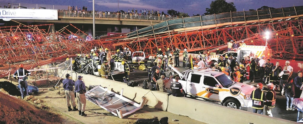 AFTERMATH Emergency personnel at the scene after the collapse of a temporary pedestrian bridge next to Grayston Drive on the M1 highway on October 14 last year. Picture: Denzel Maregele 